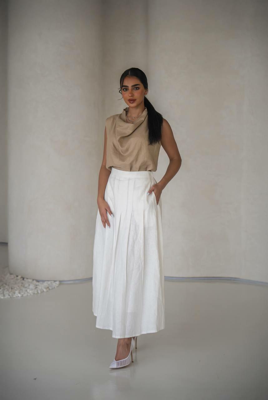 set consisting of a beige blouse with a white linen skirt