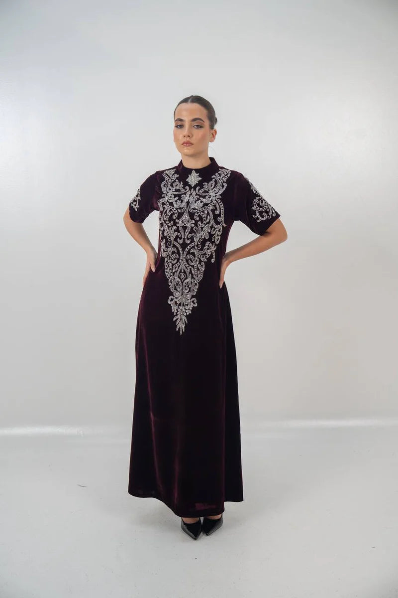 A distinctive burgundy velvet dress with hand embellishment. C:225