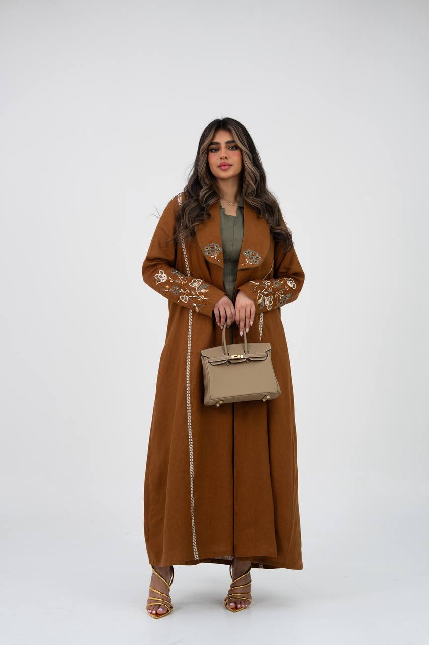 Camel-colored linen trench coat with hand embroidery and beadin