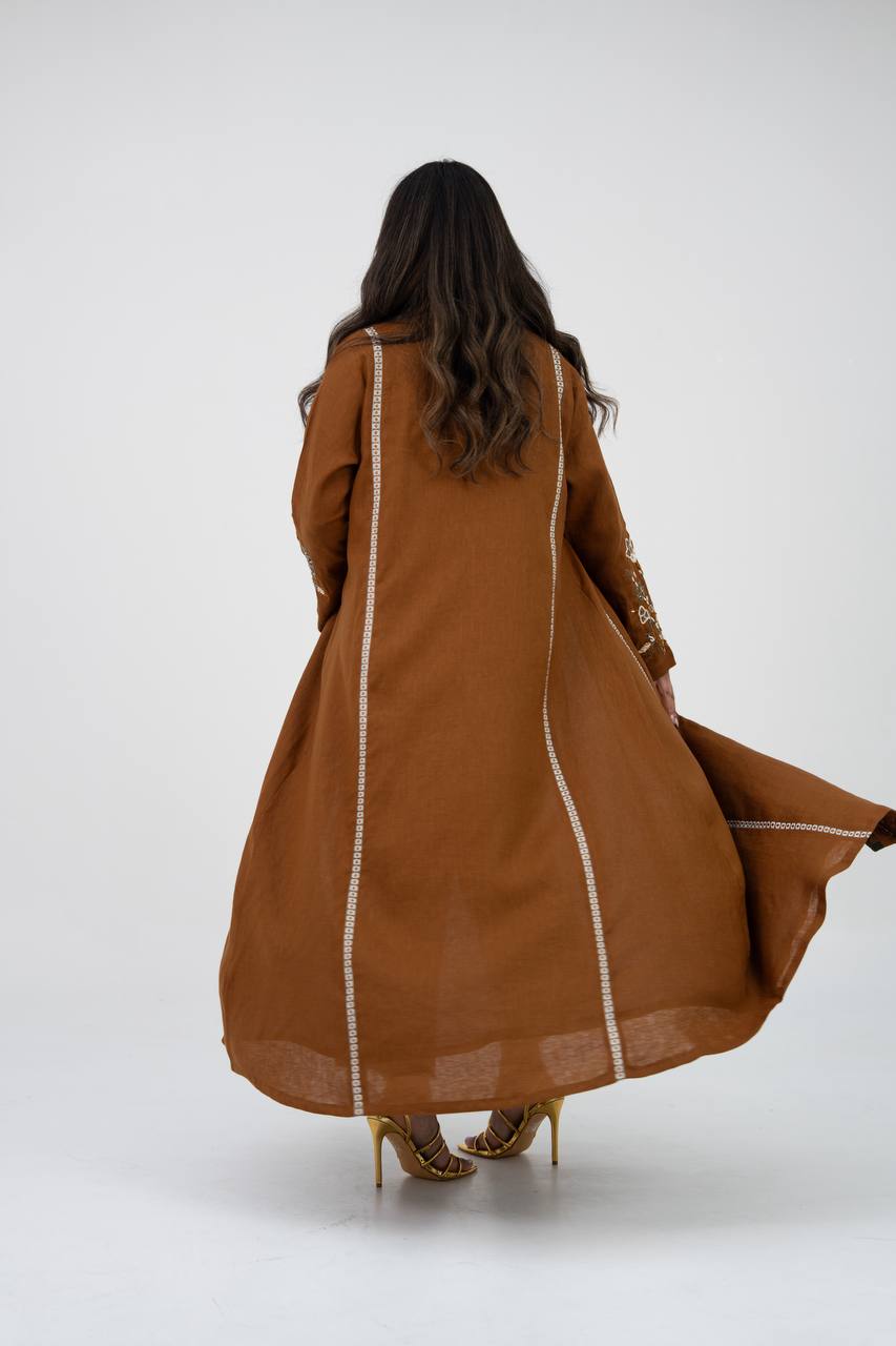 Camel-colored linen trench coat with hand embroidery and beadin