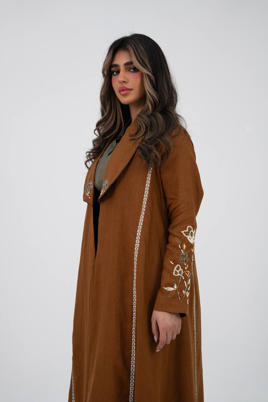 Camel-colored linen trench coat with hand embroidery and beadin