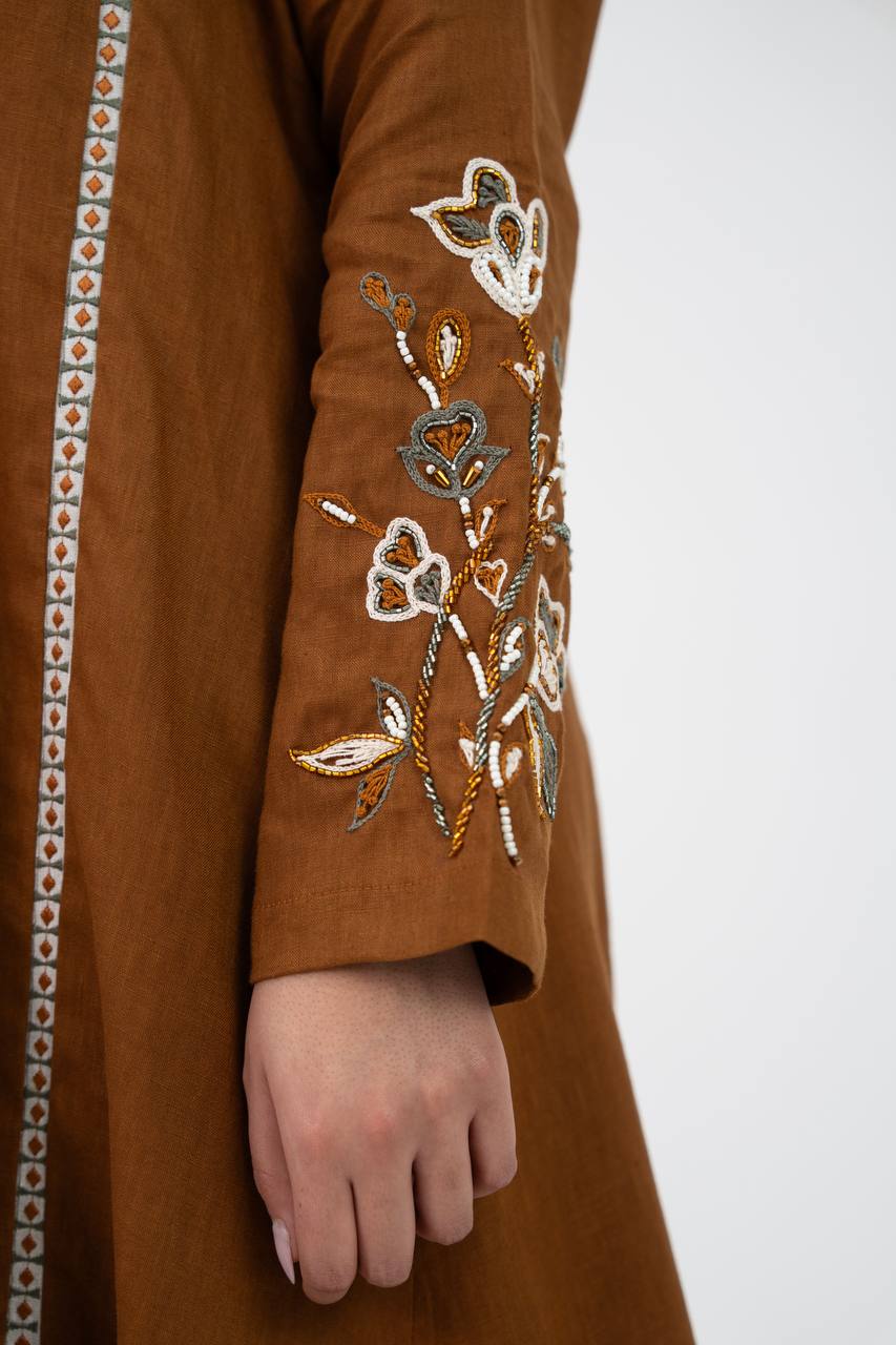 Camel-colored linen trench coat with hand embroidery and beadin