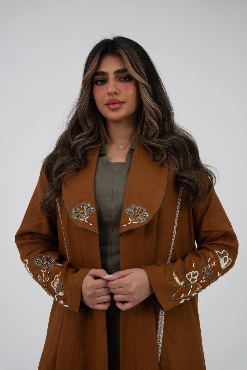 Camel-colored linen trench coat with hand embroidery and beadin