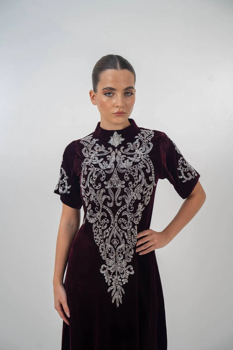 A distinctive burgundy velvet dress with hand embellishment. C:225