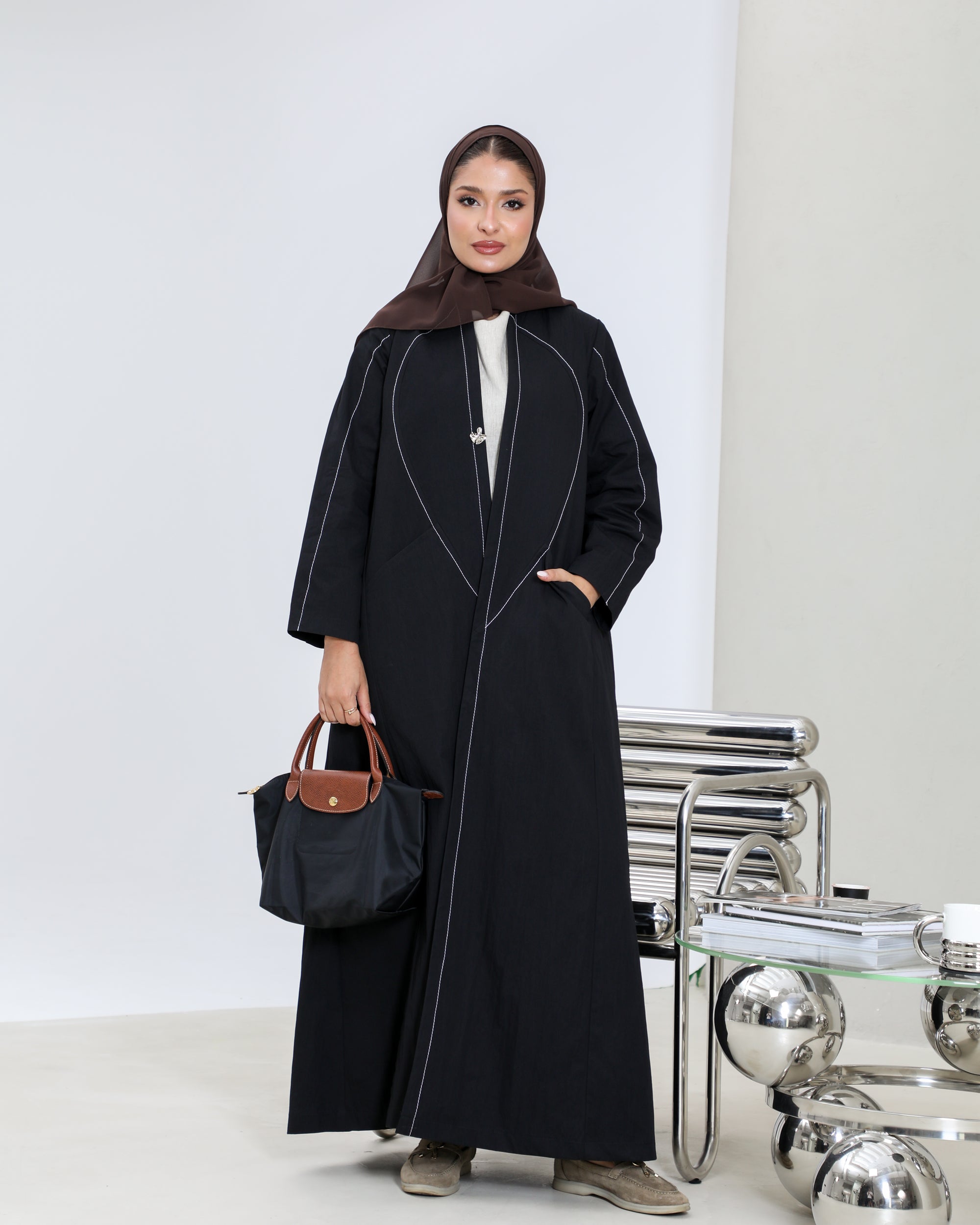 Black trench coat with white embroidery details