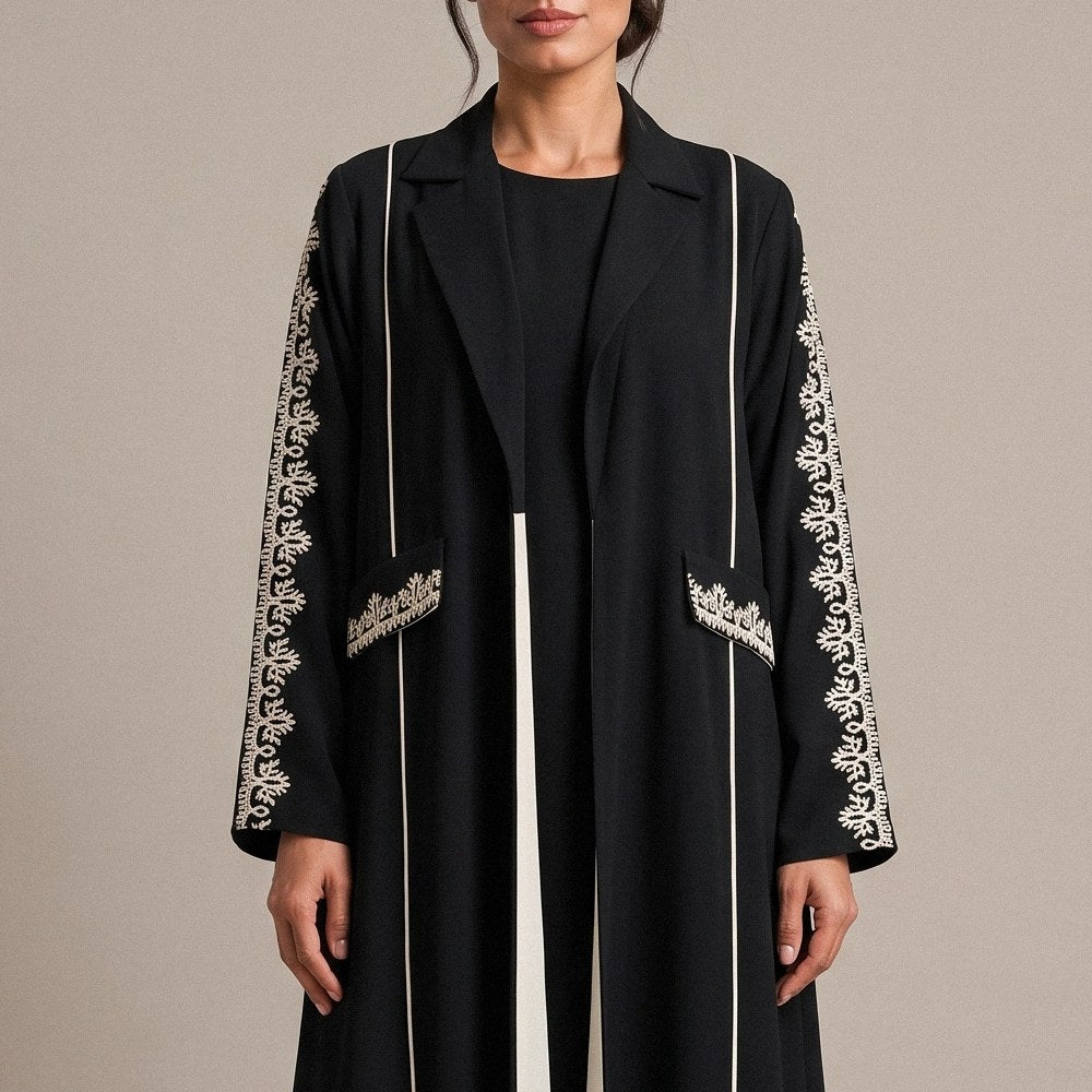 Close-up of the off-white embroidery on the sleeve of the Black Crepe Abaya.