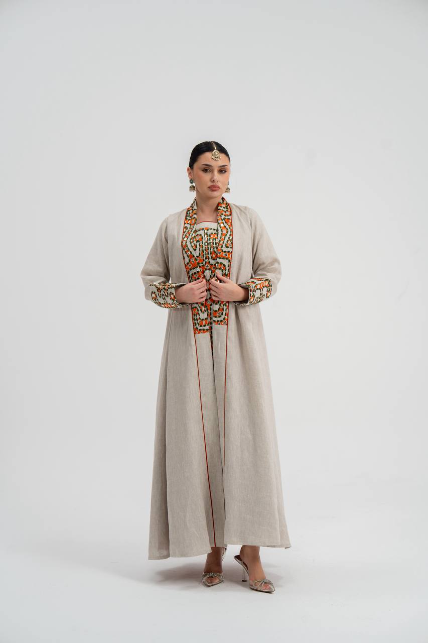 The Light Beige Linen Abaya with hand embroidery, worn over its inner set.