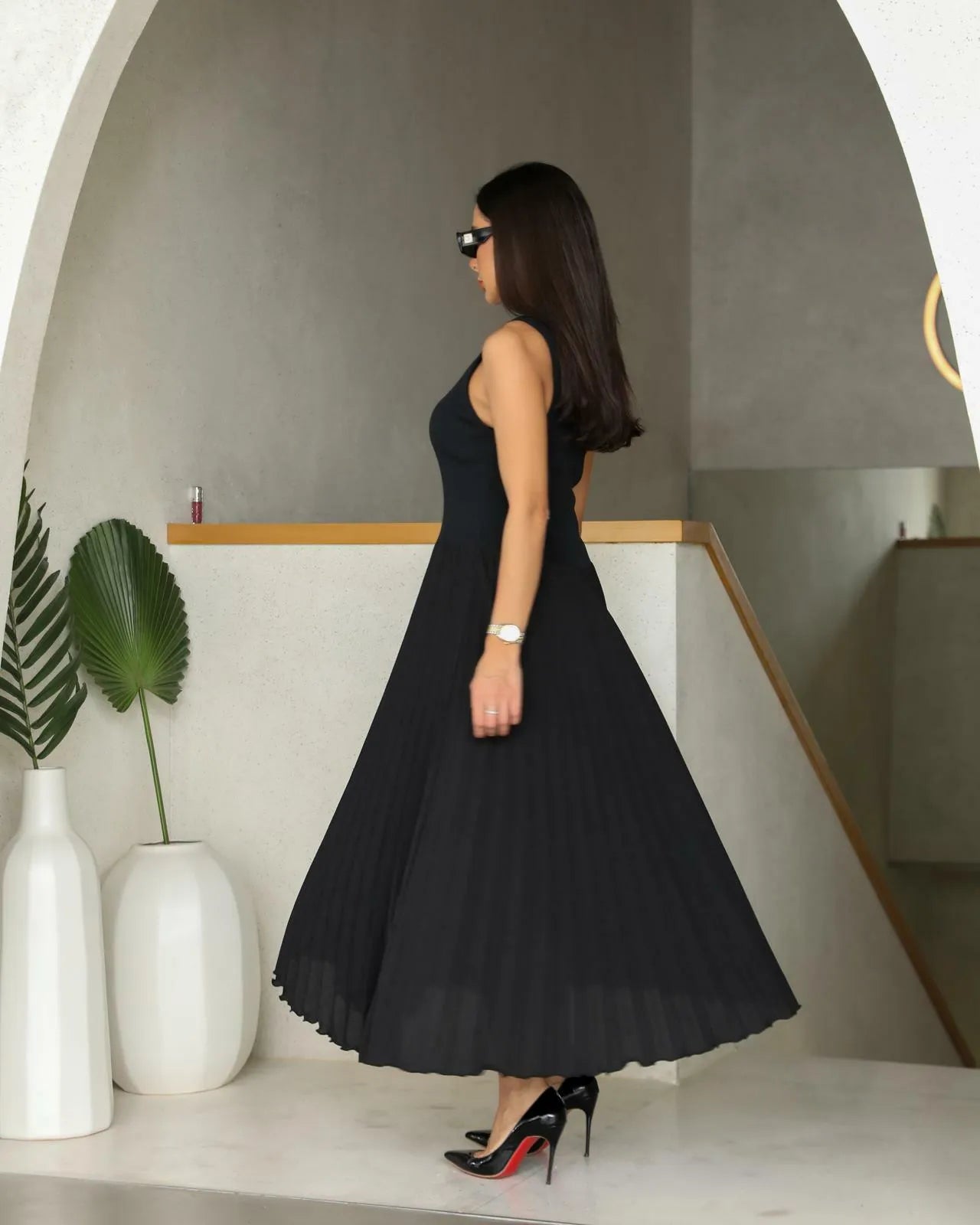 فستان أسود نصفه كريب ونصفه الآخر مطويات