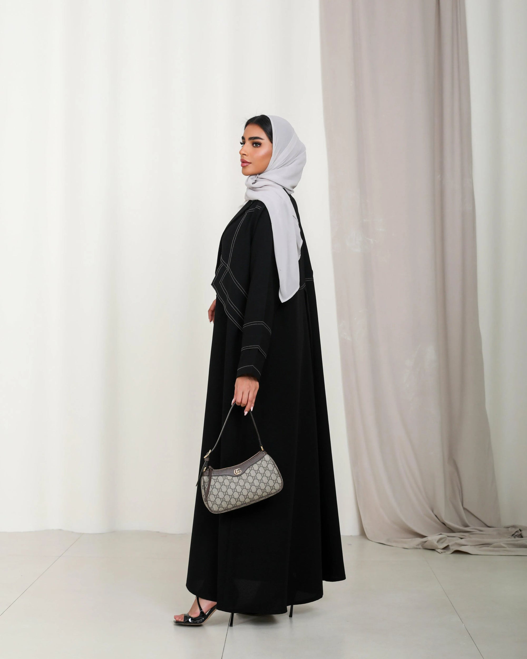 Black crepe abaya with beige stripes in the front