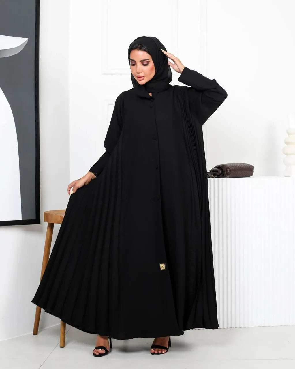 Black crepe abaya with a pleated and buttons on the front