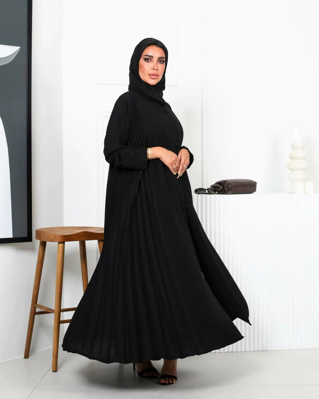 Black crepe abaya with a pleated and buttons on the front