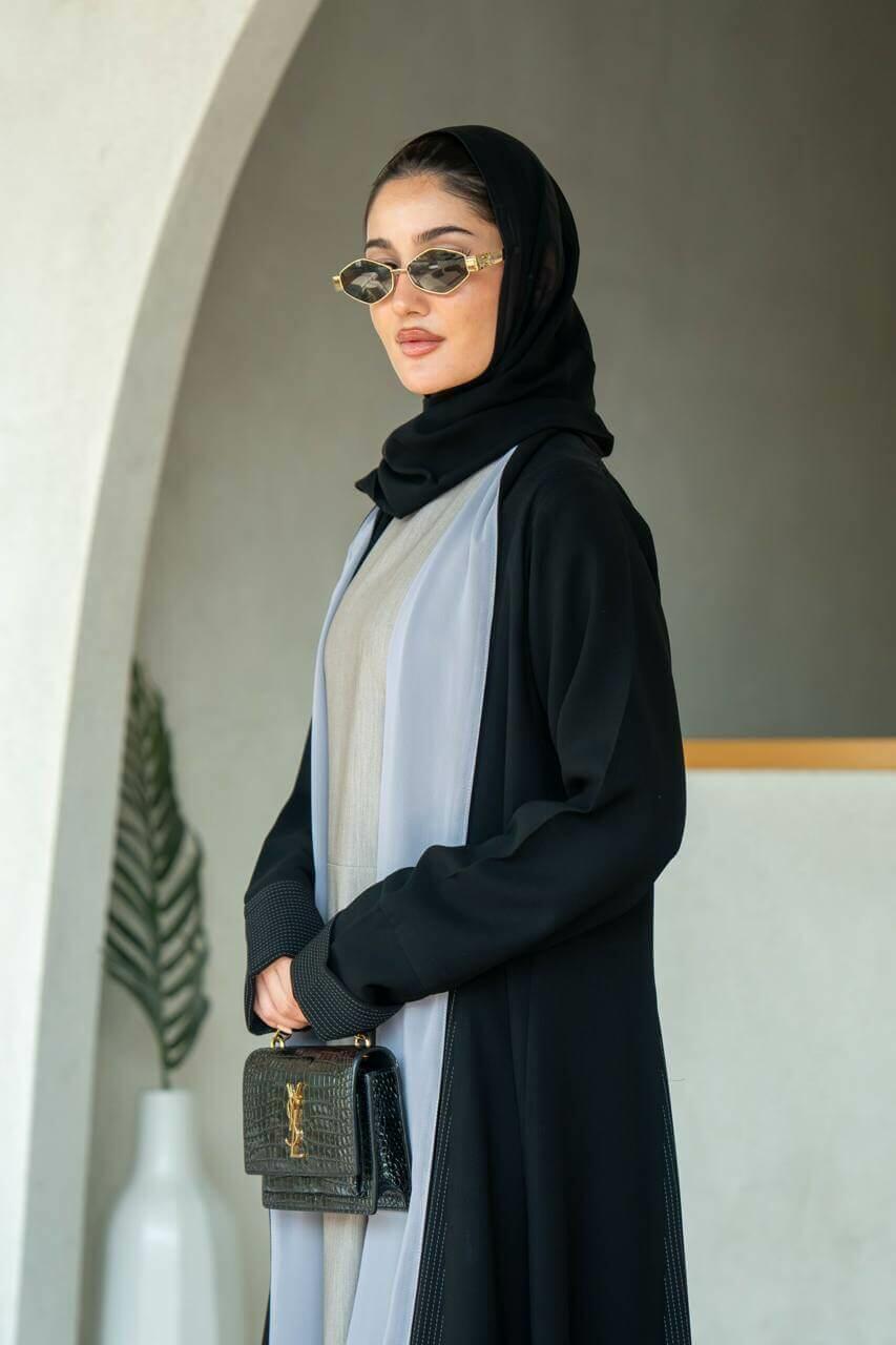 Practical black crepe abaya with striped trimming and lined with gray chiffon