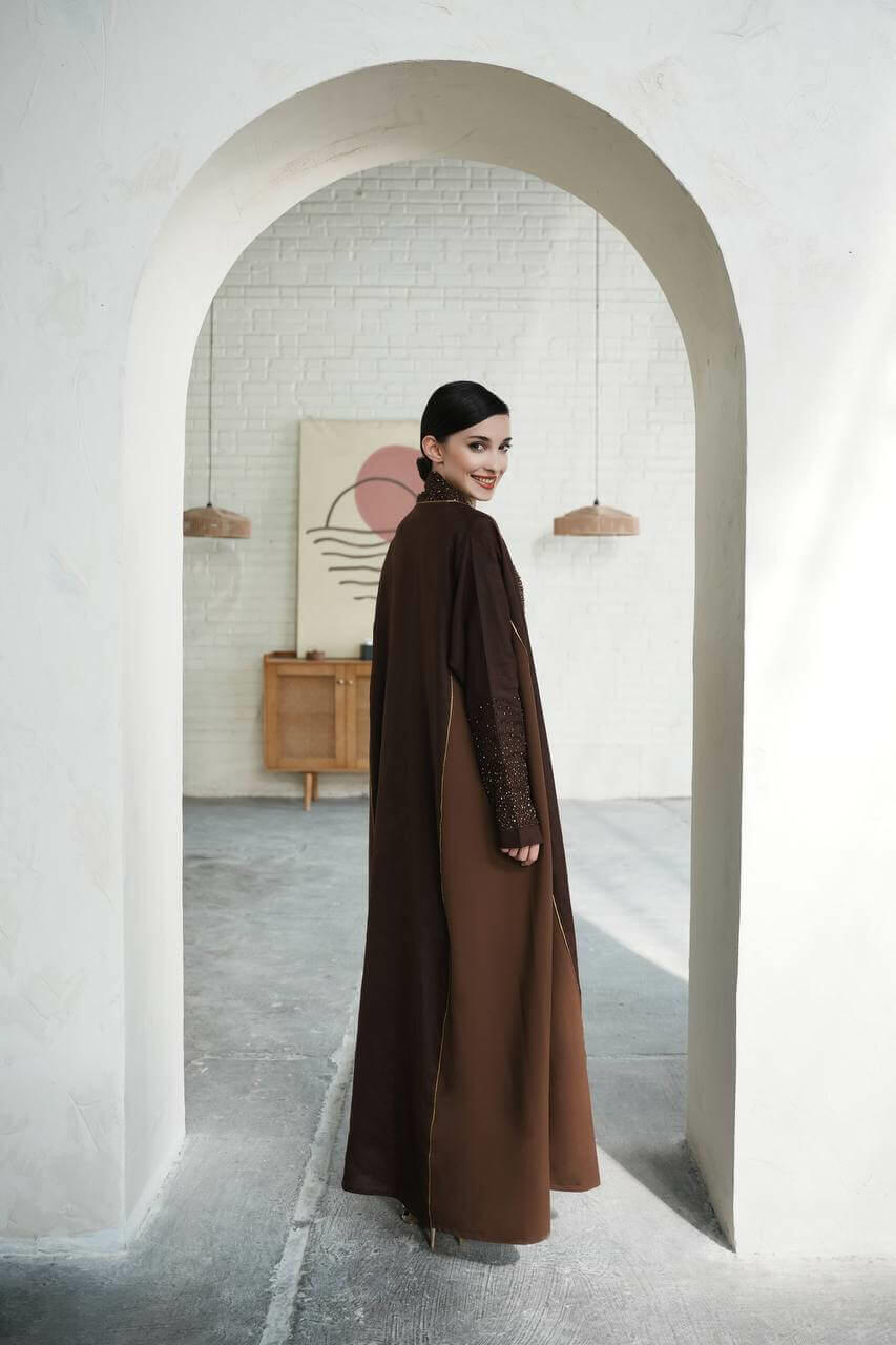 Dark brown linen abaya with the addition of light brown on the sides with luxurious hand embroidery