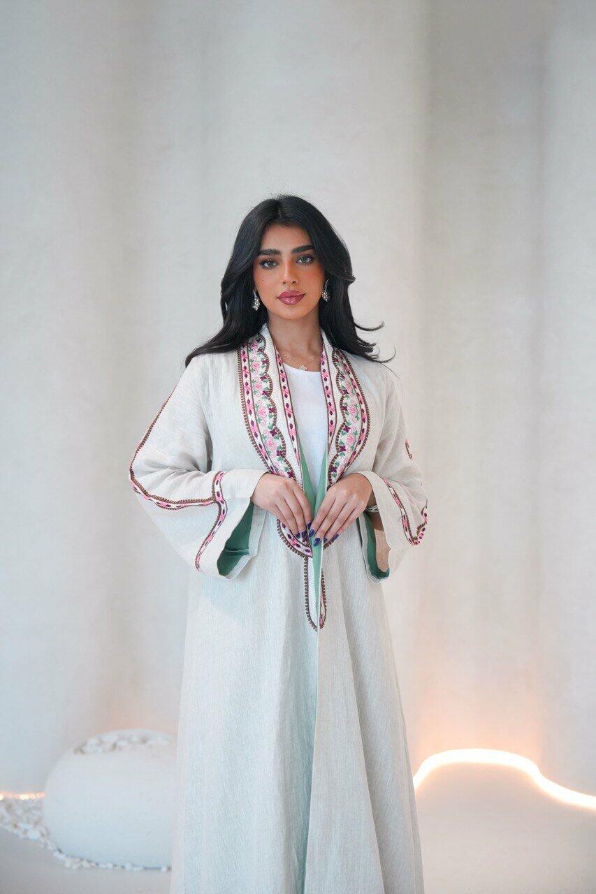 Beige linen abaya with a pistachio chiffon lining and pink,red embroidery