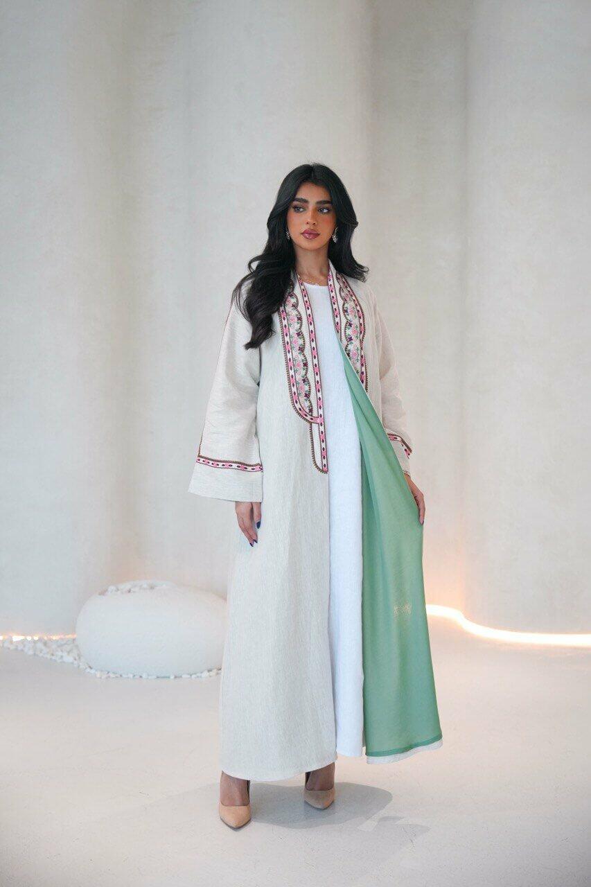Beige linen abaya with a pistachio chiffon lining and pink,red embroidery