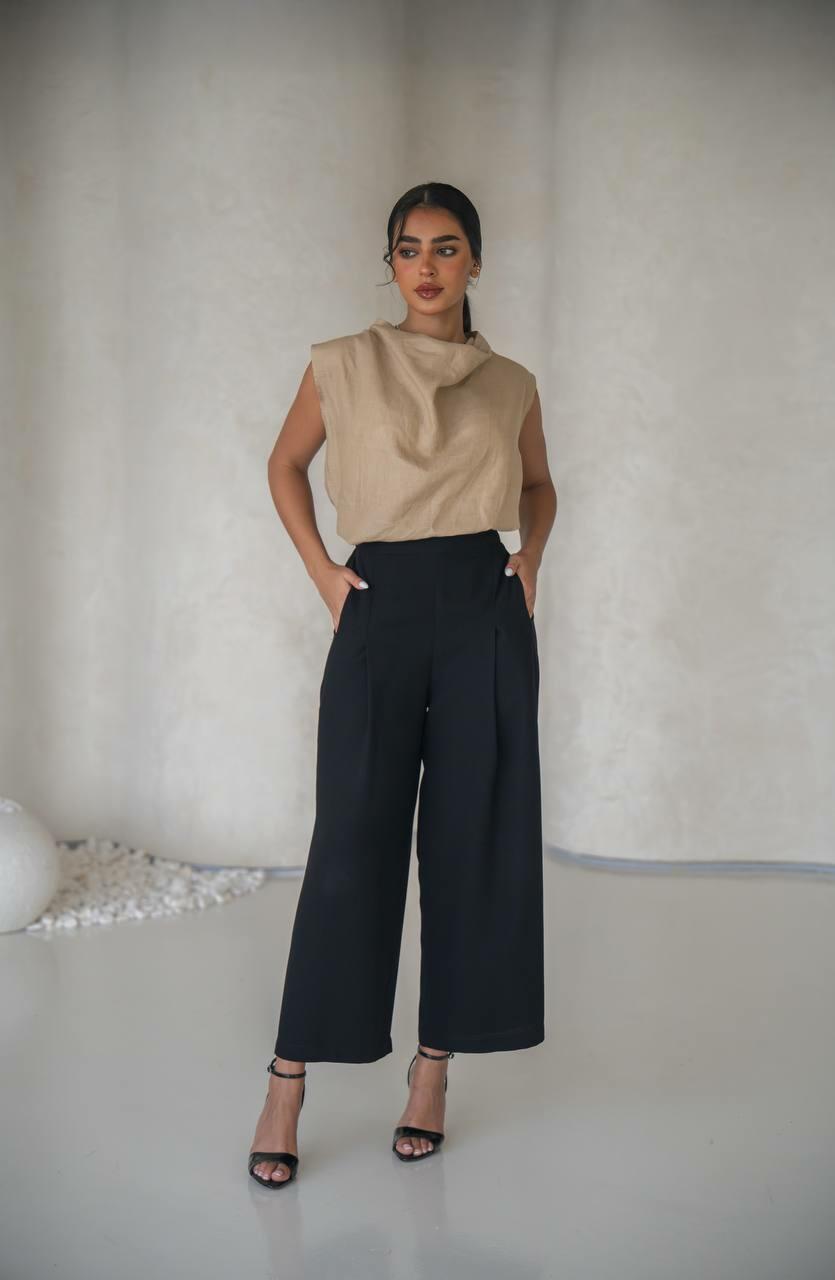 set consisting of a beige linen blouse with black pants