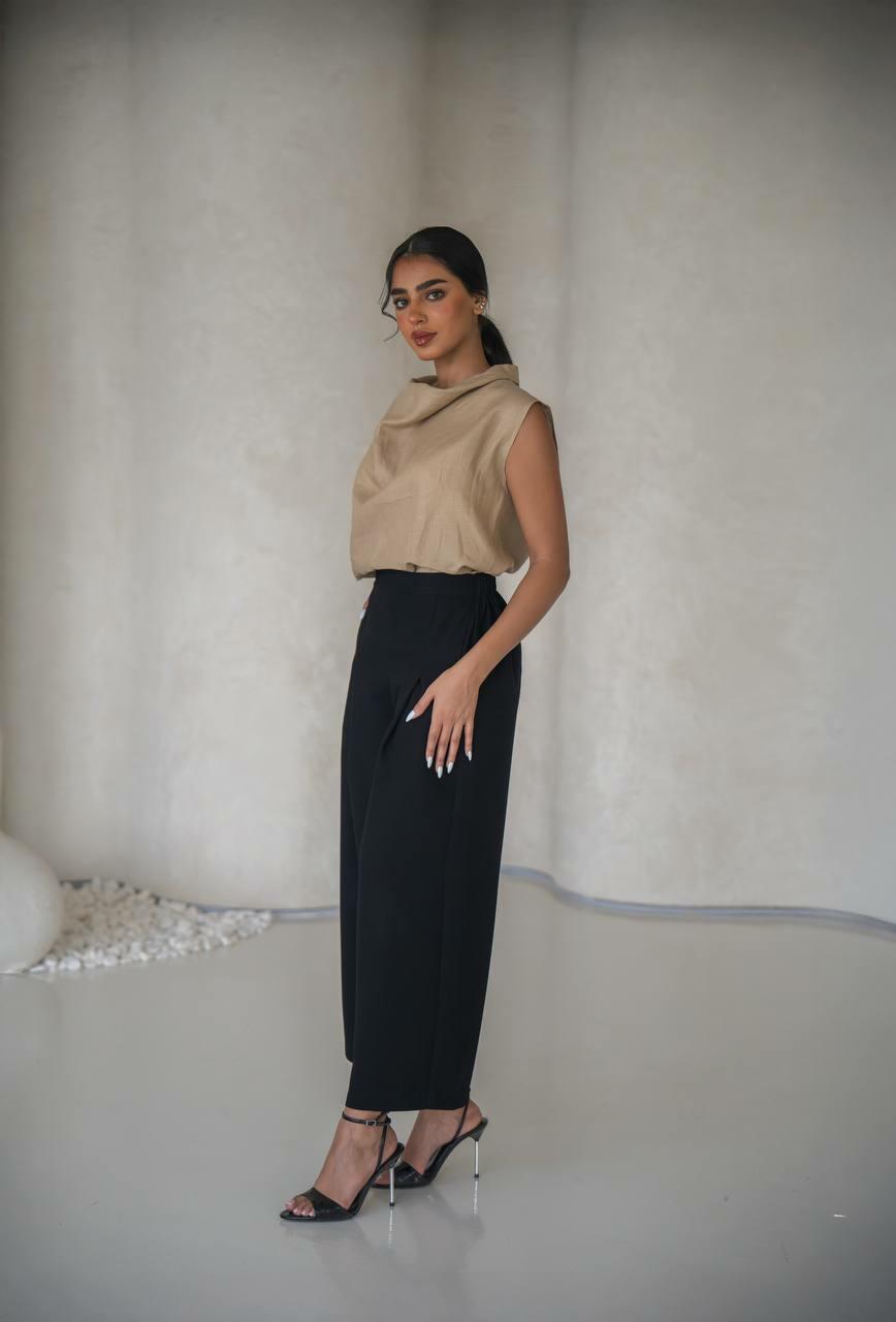 set consisting of a beige linen blouse with black pants