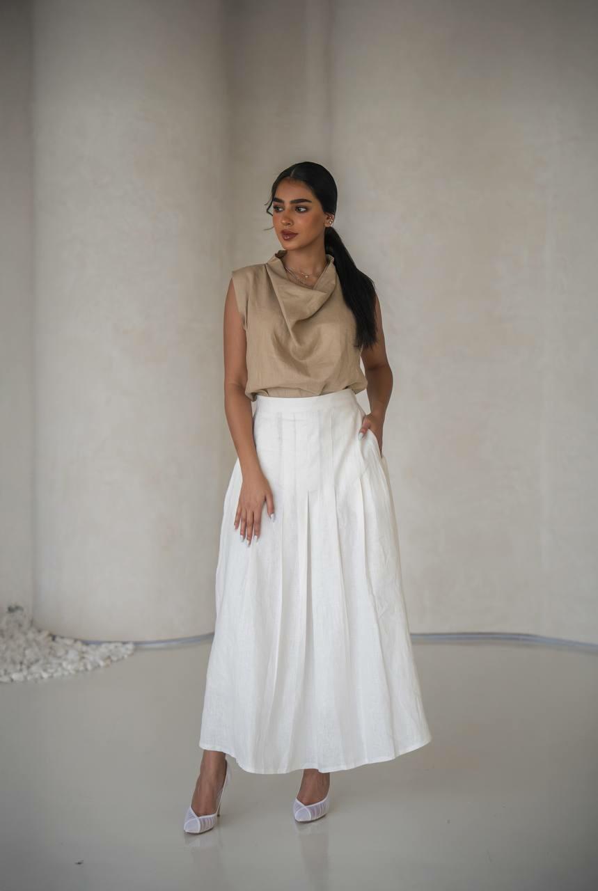 set consisting of a beige blouse with a white linen skirt