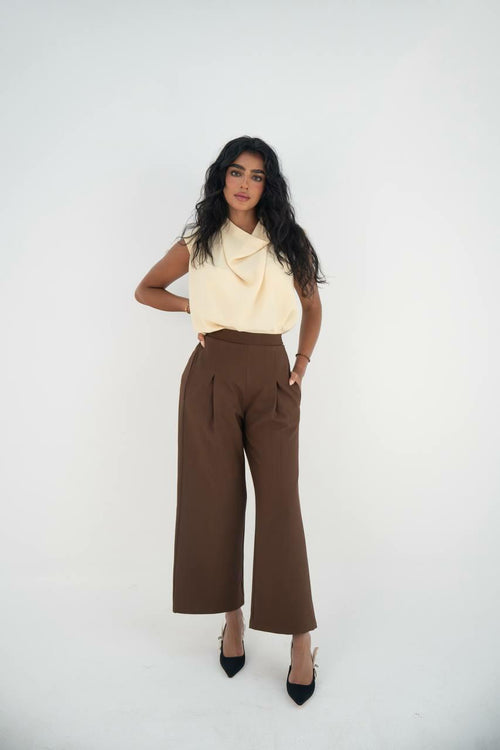 A practical set consisting of a blouse and brown pants made of linen