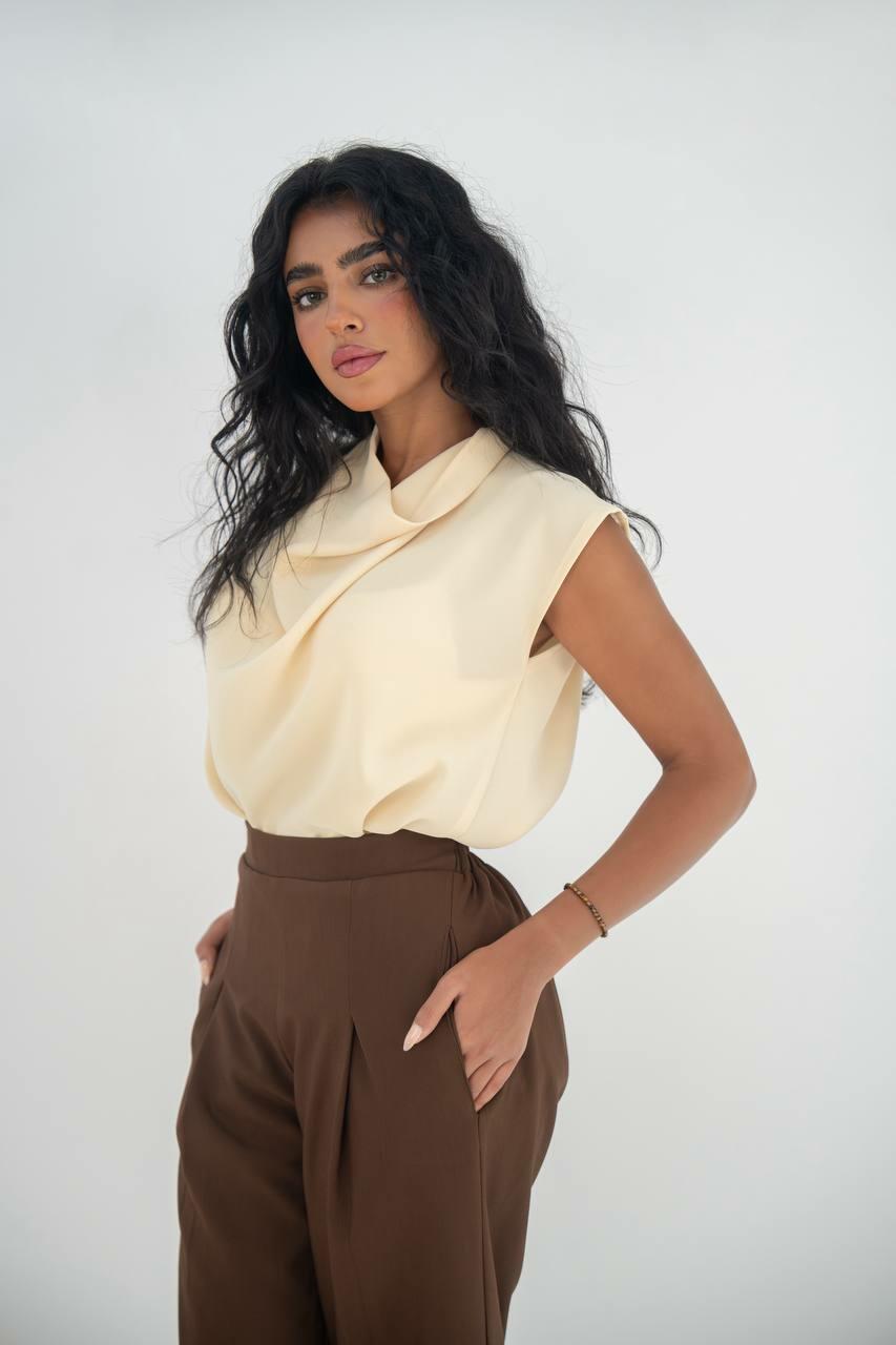 A practical set consisting of a blouse and brown pants made of linen