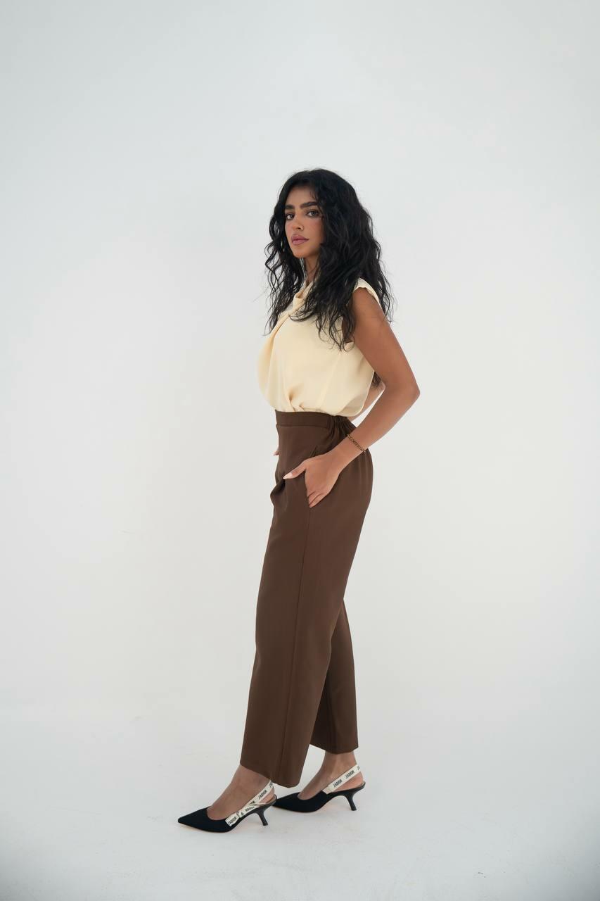 A practical set consisting of a blouse and brown pants made of linen