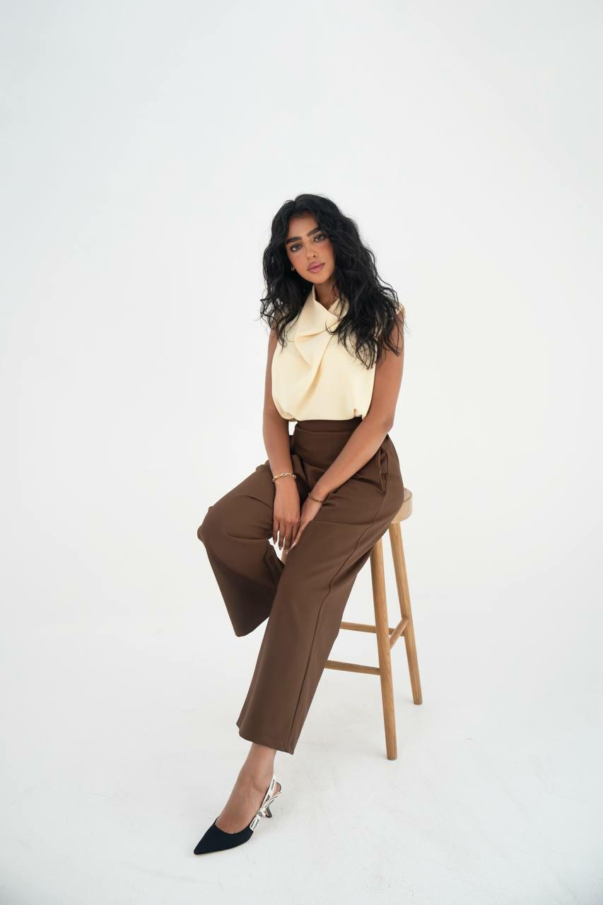 A practical set consisting of a blouse and brown pants made of linen