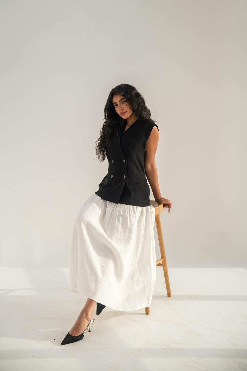 set consisting of a black crepe vest with a white linen skirt