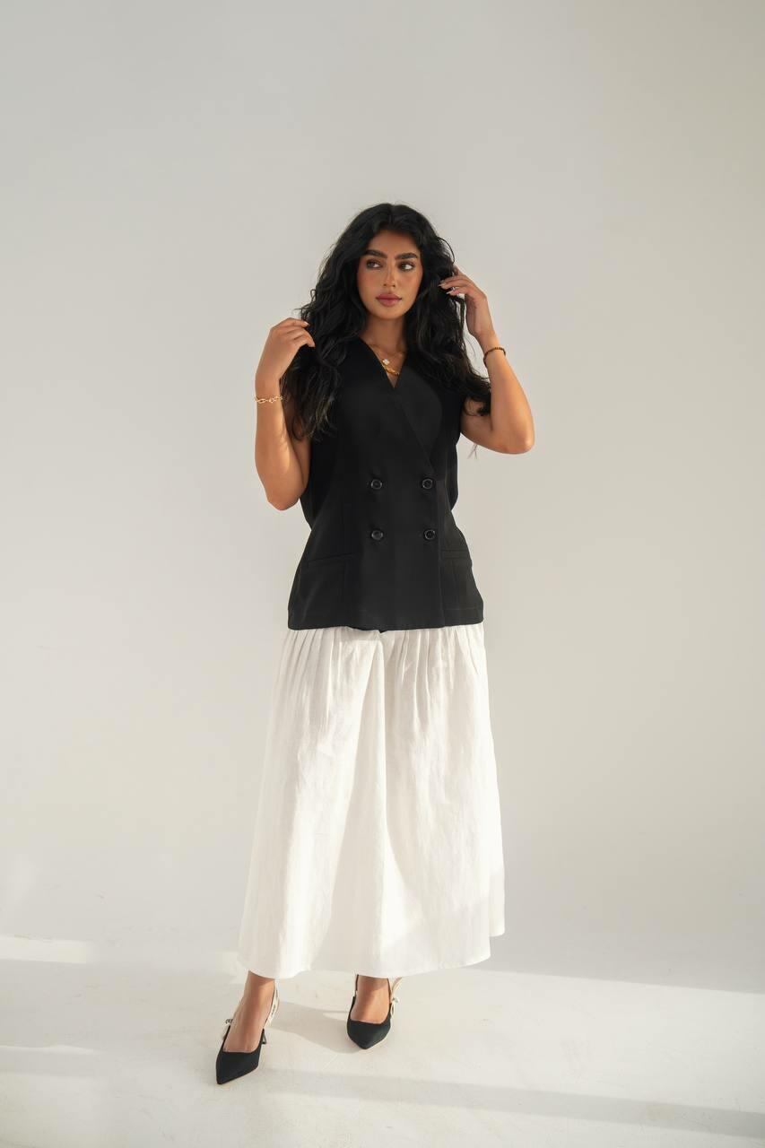 set consisting of a black crepe vest with a white linen skirt