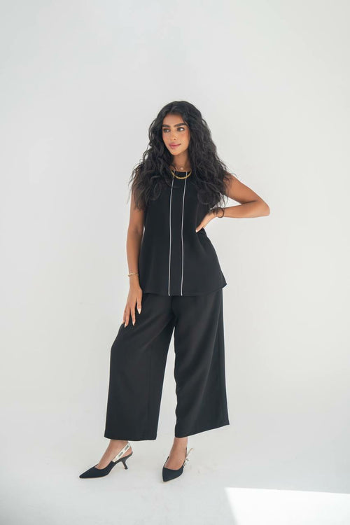 A blouse and pants set in black crepe