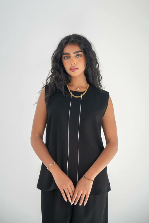 A blouse and pants set in black crepe