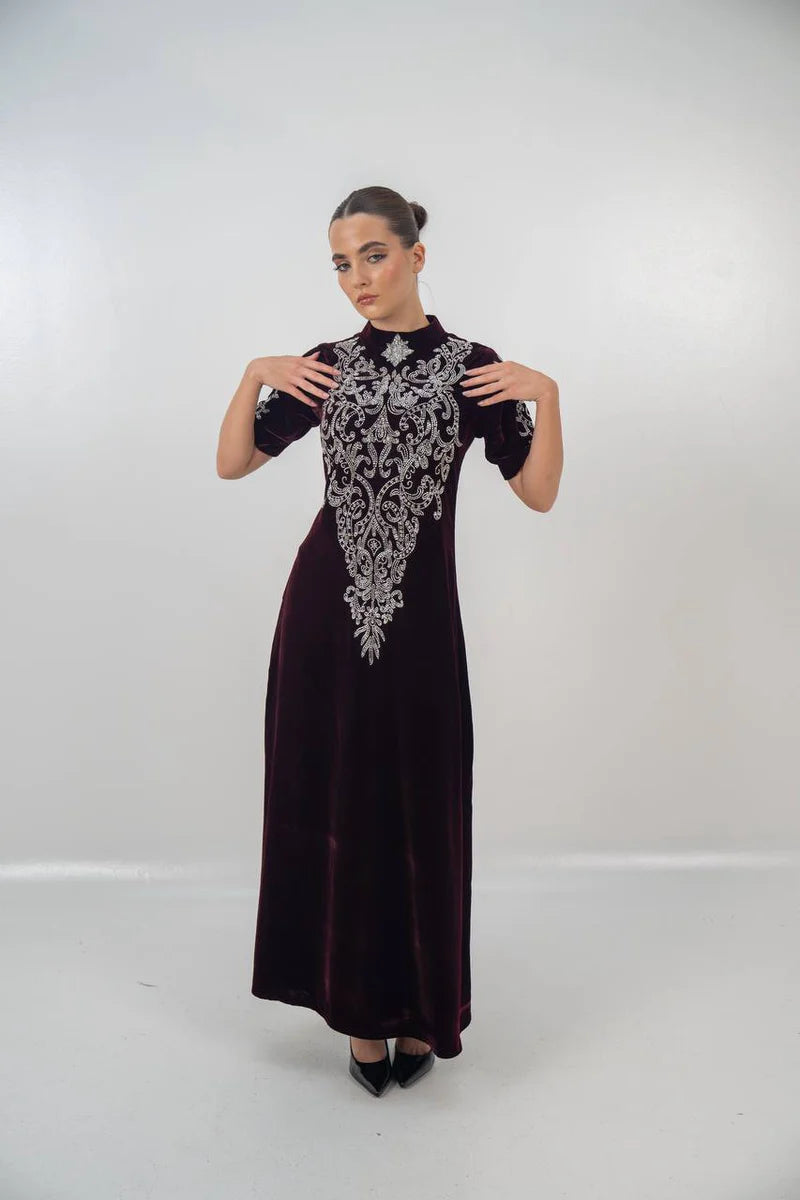 A distinctive burgundy velvet dress with hand embellishment. C:225
