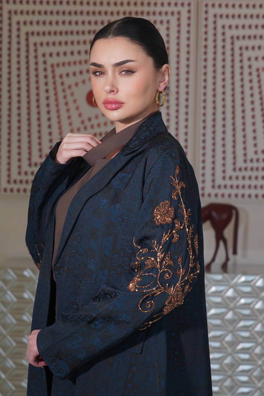 A navy blue jacquard silk blazer abaya with hand-stitched details