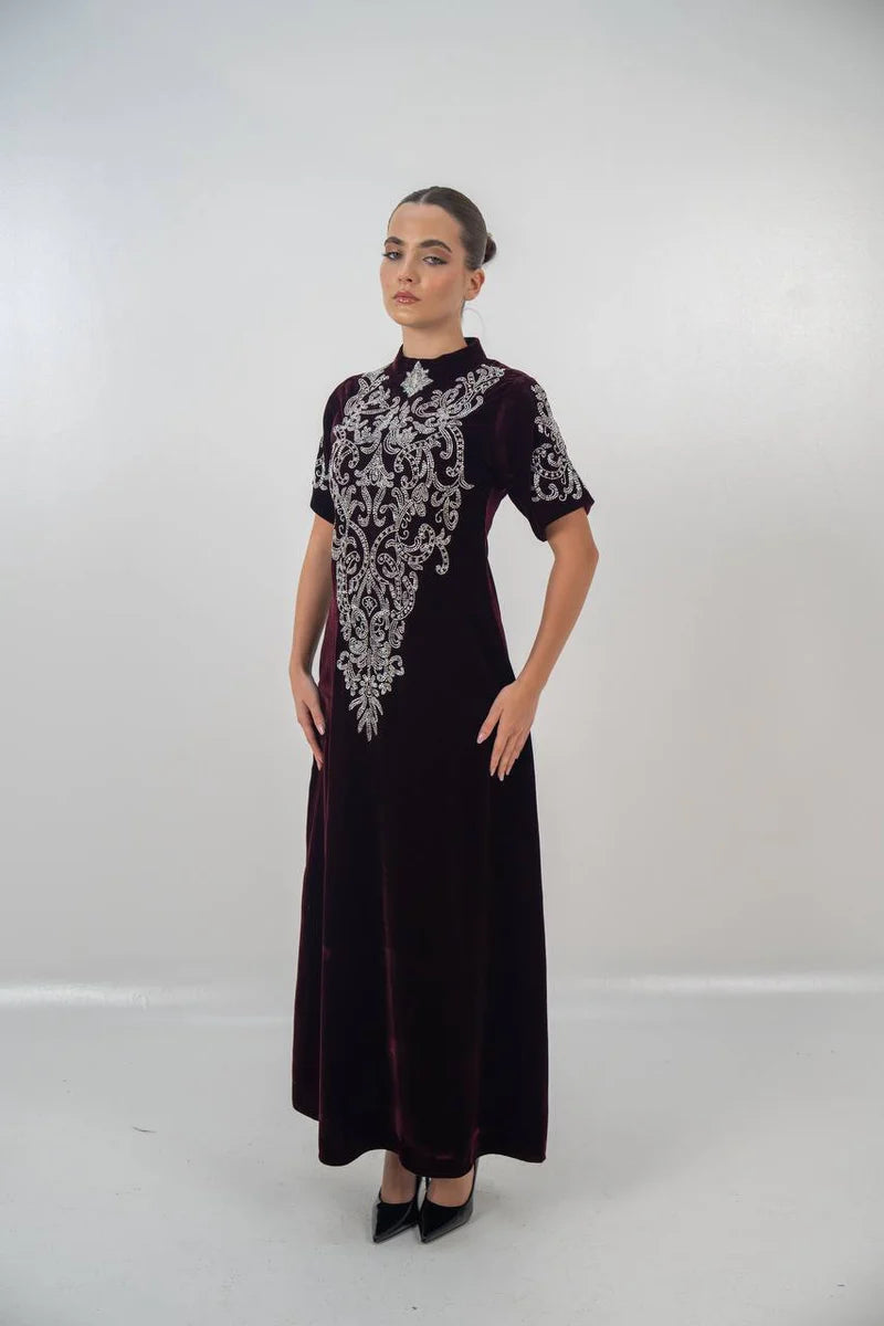 A distinctive burgundy velvet dress with hand embellishment. C:225