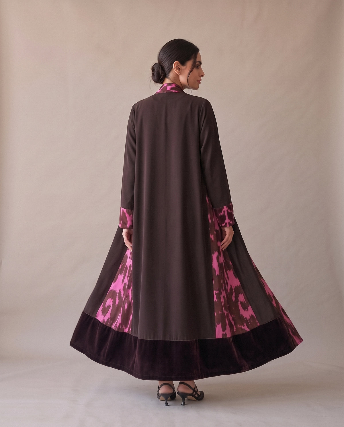 The Brown Velvet Abaya with Pink Print from the back: the skirt swinging open on the print.
