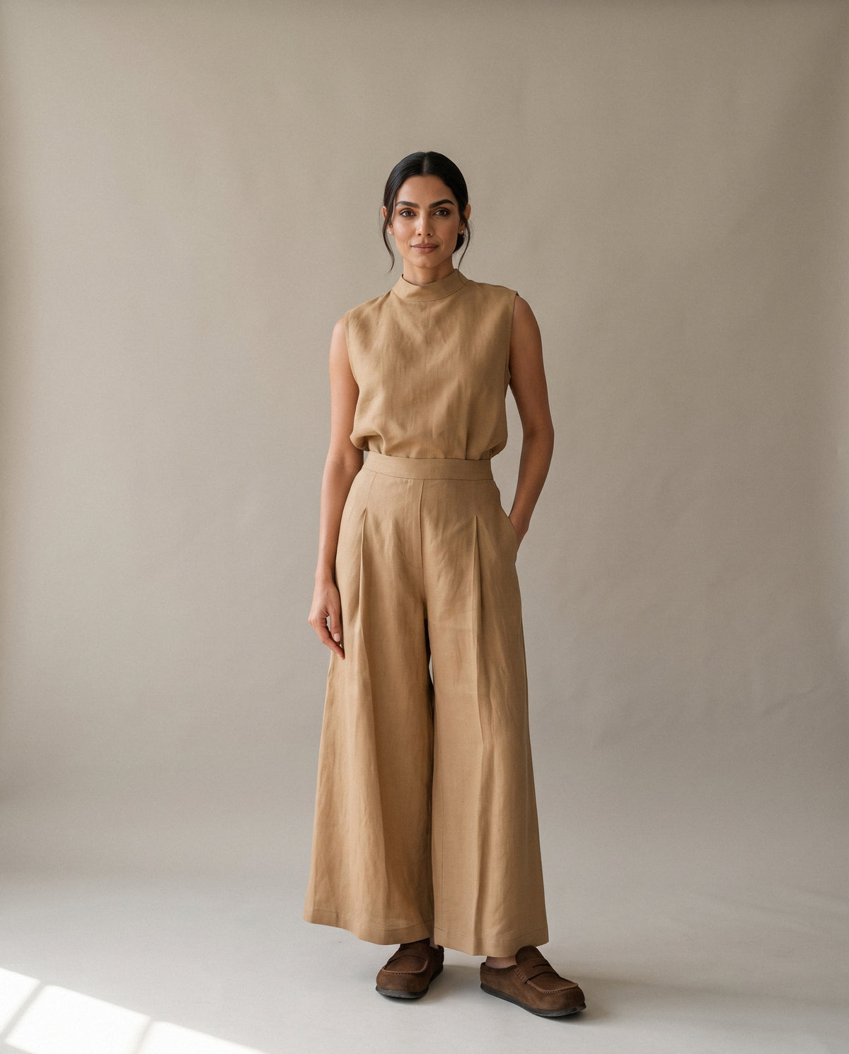 The Beige Linen Pants & Blouse Set from the front: a sleeveless high-neck blouse over wide trousers.