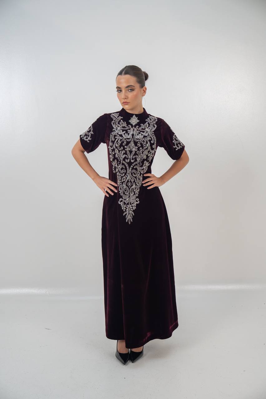 A distinctive burgundy velvet dress with hand embellishment. C:225