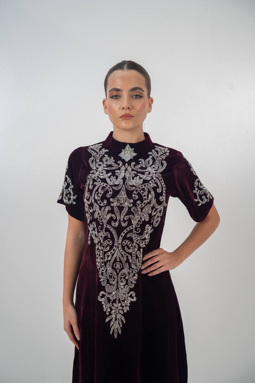 A distinctive burgundy velvet dress with hand embellishment. C:225