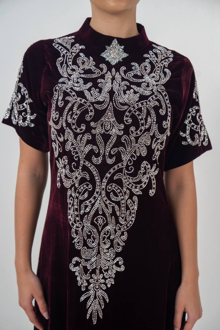 A distinctive burgundy velvet dress with hand embellishment. C:225