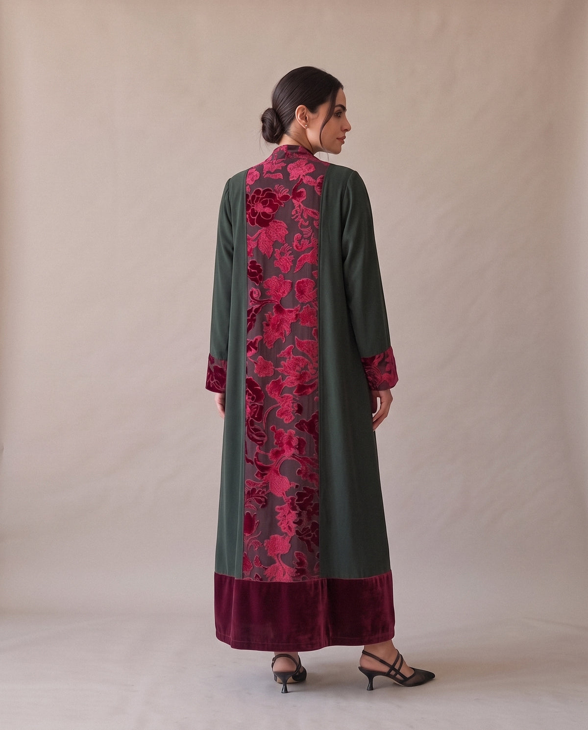 The Green Velvet Abaya from the back: one wide panel of crimson floral velvet from the collar to the hem.